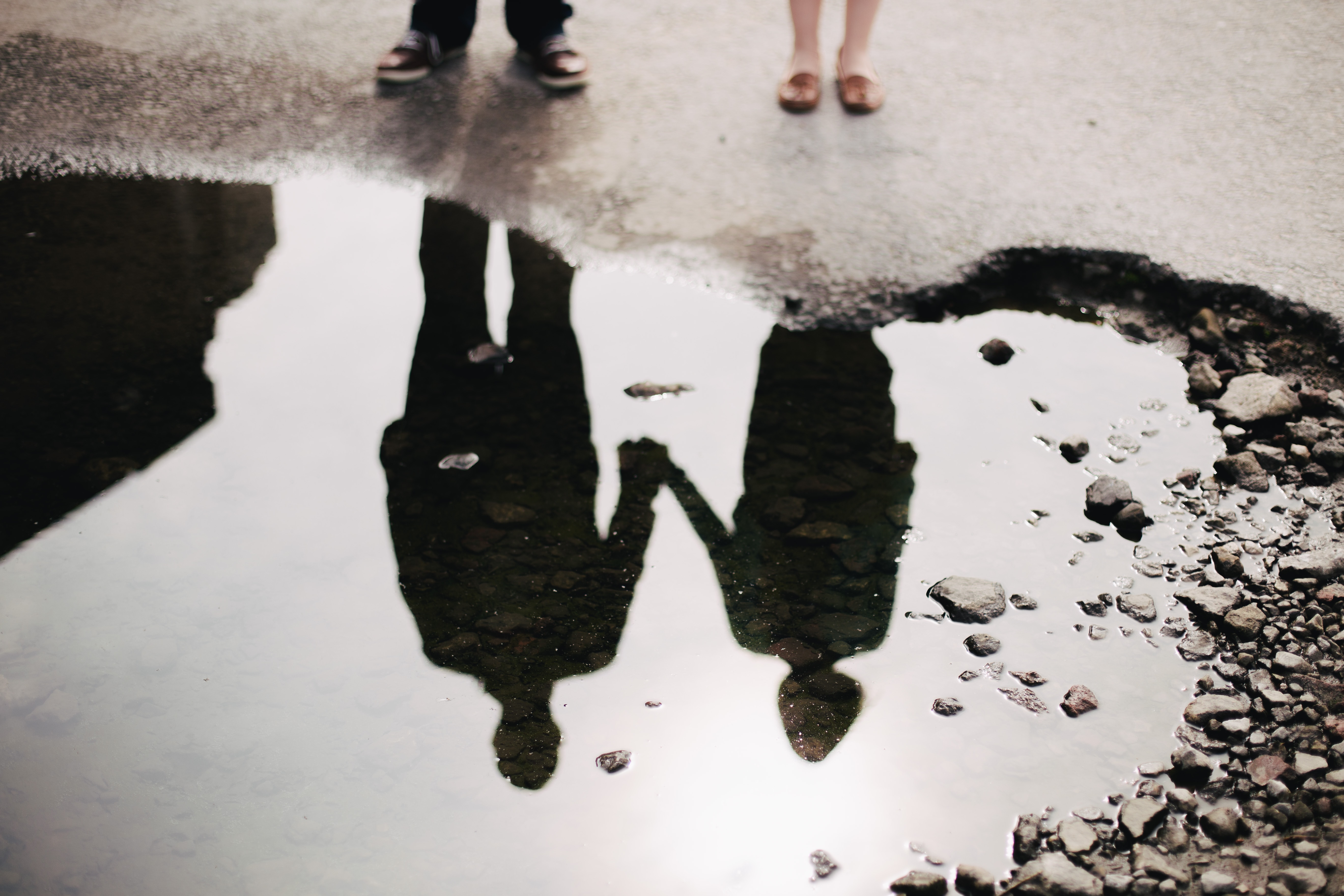 SIlhouette reflection of two people holding hands.