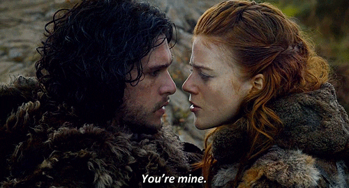 Ygritte and Jon Snow from Game of Thrones are inches apart as Ygritte tells Jon, "You're mine."