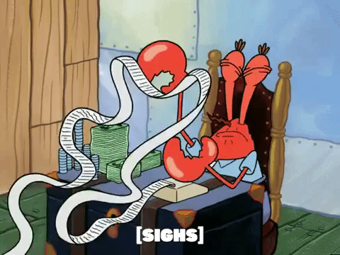 Eugene Krabs from Spongebob Squarepants sobs at his desk which is cluttered with paperwork and money.