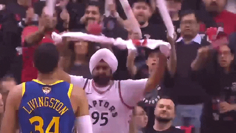 Raptors Superfan waving around towel at game