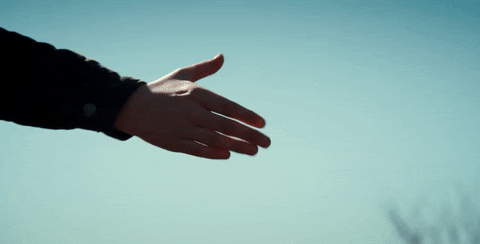 Close-up of two people shaking hands from season one of Netflix's "Stranger Things".