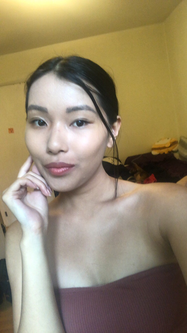 Fourth year University of Guelph-Humber psychology student Amy Vong holds her hand up to hear face and smirks at the camera.