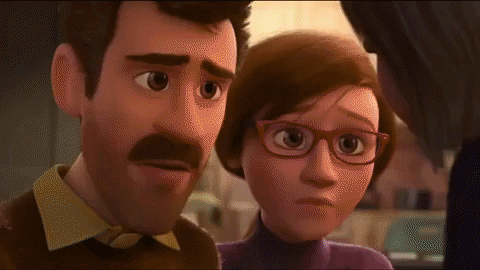 Riley from Disney-Pixar's "Inside Out" (2015) is hugged by her mother and father. Inside her head, Joy's eyes narrow as she appears to realize the importance of feeling sad.