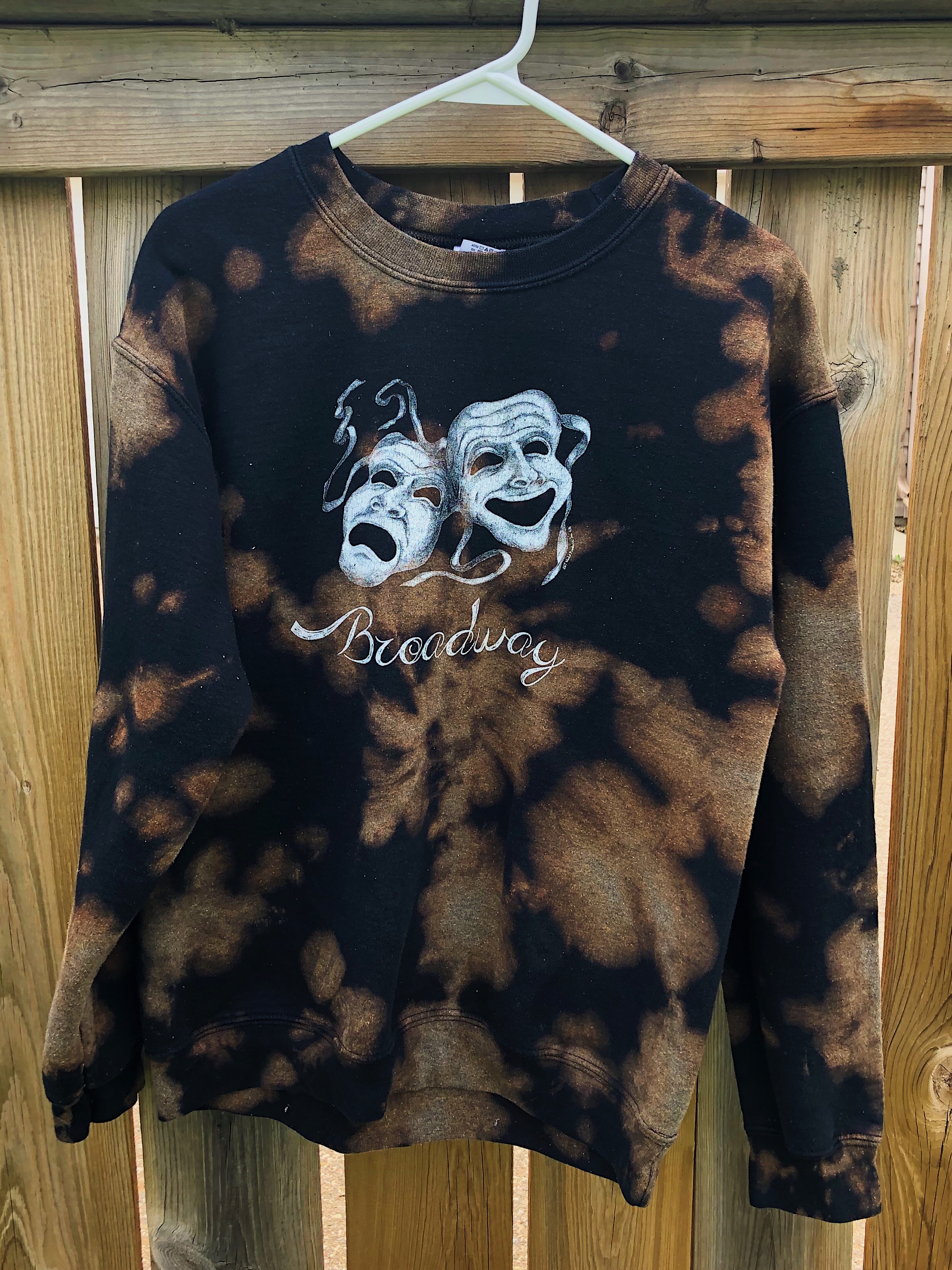 A black hoodie tie-dyed with bleach.