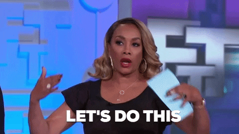 Actress Vivica Fox wears a black dress and holds a piece of paper in her left hand. She crosses her arms and exclaims, "Let's do this!"
