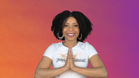 A woman wearing a white T-shirt mouths the words, "I got you," while pointing at herself and the camera, respectively.