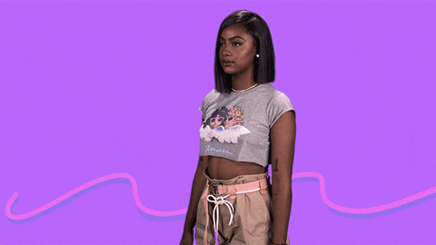 Musician Justine Skye stands against a neon purple background as an animated lighting bolt flashes between her fists.