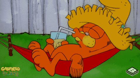 Garfield the cat relaxes in a fenced yard while wearing a straw hat and drinking lemonade.