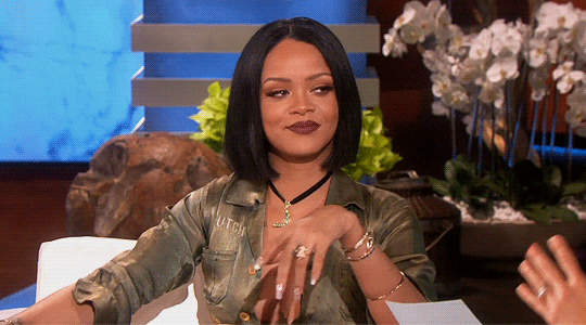 Rihanna points and winks.
